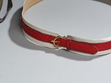 a red and white belt with a gold buckle on it