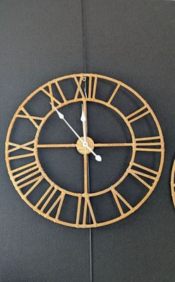 two clocks on the wall with roman numerals on each of them