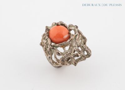an image of a ring with a coral stone in the center