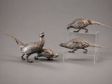 three silver colored pheasants on clear acrylic stands