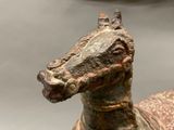 a statue of a horse that is on display in a museum