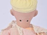 a small doll with a yellow hat on it ' s head