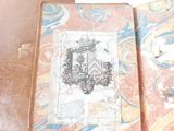 an old book with a picture of a coat of arms on it