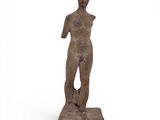 a statue of a man standing on a rock with his hands in his pockets