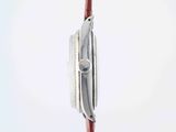 a close up of a watch on a red cord