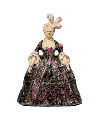 a figurine of a woman in a black dress with pink flowers