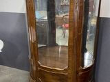 a wooden cabinet with a glass door in the middle of it