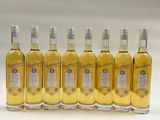 six bottles of white wine are lined up in a row
