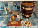 a wooden bucket on the counter next to a bottle of liquor