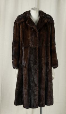 an image of a woman ' s fur coat on a mannequin stand