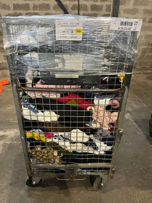 a metal cart with a bunch of shoes in it