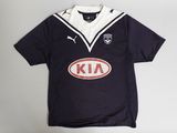 a close up of a black and white shirt with an oval logo on it