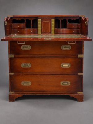 an antique mahogany bureau with brass handles and drawers