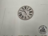 a clock on the wall with roman numerals on it