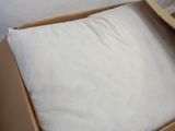 a box with a pillow inside of it on the floor
