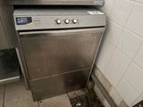 a silver dishwasher sitting in the corner of a kitchen