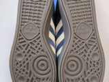 adidas shoes with blue and white stripes on the soles