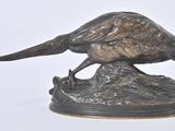 a bronze statue of a pheasant on top of a rock