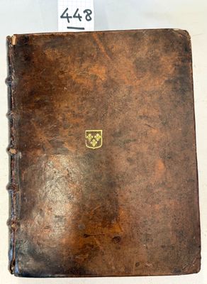 an old book with a label on it sitting on a table