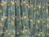 yellow and green floral curtains hanging on a wall in a room