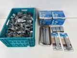 many different types of screws in a plastic container