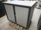 a cabinet that is sitting on a pallet in a warehouse