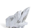 a white sculpture of a leaf on a white surface
