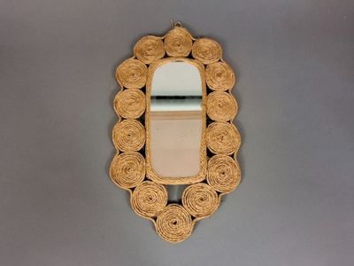 a decorative mirror hanging on the wall next to a sink