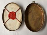two pans with wax on them sitting on a table