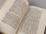 an open book on a table with a white background