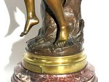 statue of a woman sitting on a rock holding a baby