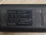 a black battery charger sitting on a wooden table