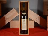 a bottle of wine in a wooden box on a table