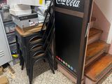 a refrigerator and some chairs in a room with boxes on the floor