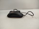 a black computer mouse sitting on a white surface