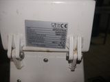 a close up of a white machine with a label on it