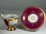 a cup and saucer sitting next to each other on a table