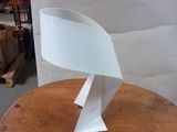 a white lamp that is sitting on a wooden table