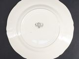 a close up of a white plate on a black surface