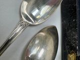 two spoons sitting next to each other on a table