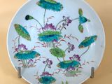 a white plate with blue flowers and green leaves on it