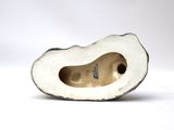 porcelain figurine of a woman ' s shoe on a white surface