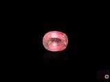 a pink diamond on a black background