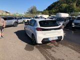 cars parked in a parking lot with a man walking by