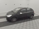 a picture of a small black car parked in a garage