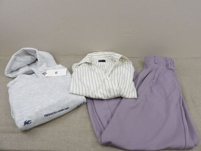 three pieces of clothing sitting on a bed next to each other