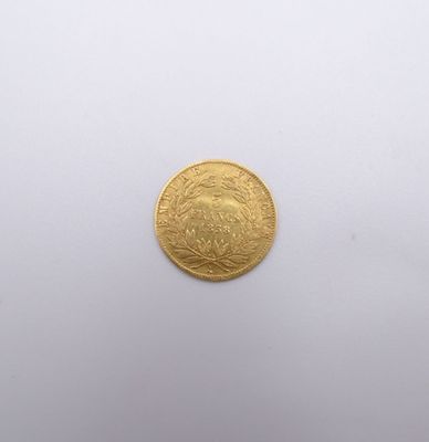 a close up of a gold coin on a white surface