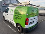 a green and white van parked in a parking lot
