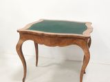 a small wooden table with a green glass top