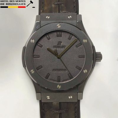 an image of a wrist watch with a black dial and brown leather strap